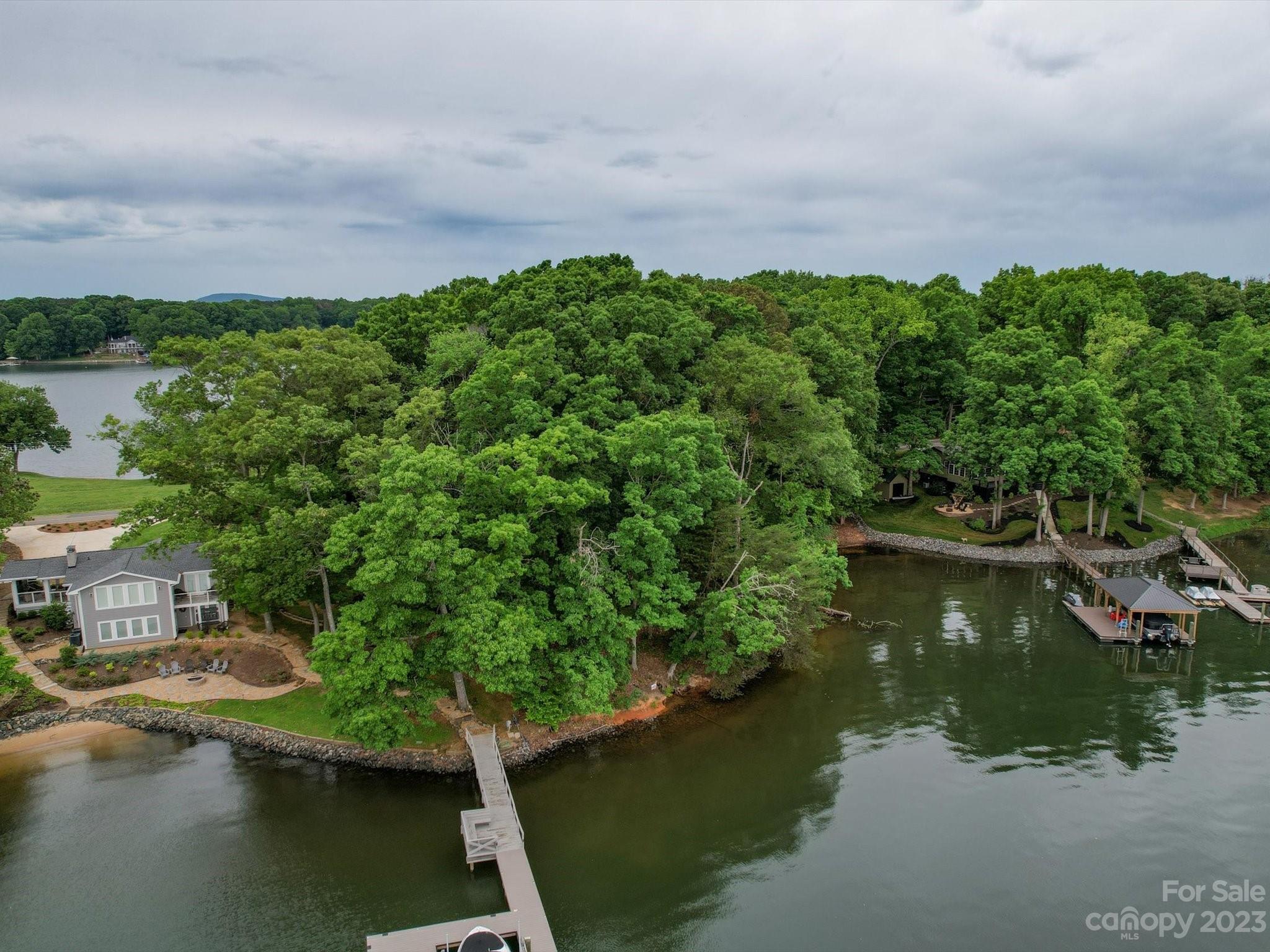 4614 Kiser Island Road Terrell, NC 28682 - Photo 25 of 28 a view of a lake with lawn chairs and large trees