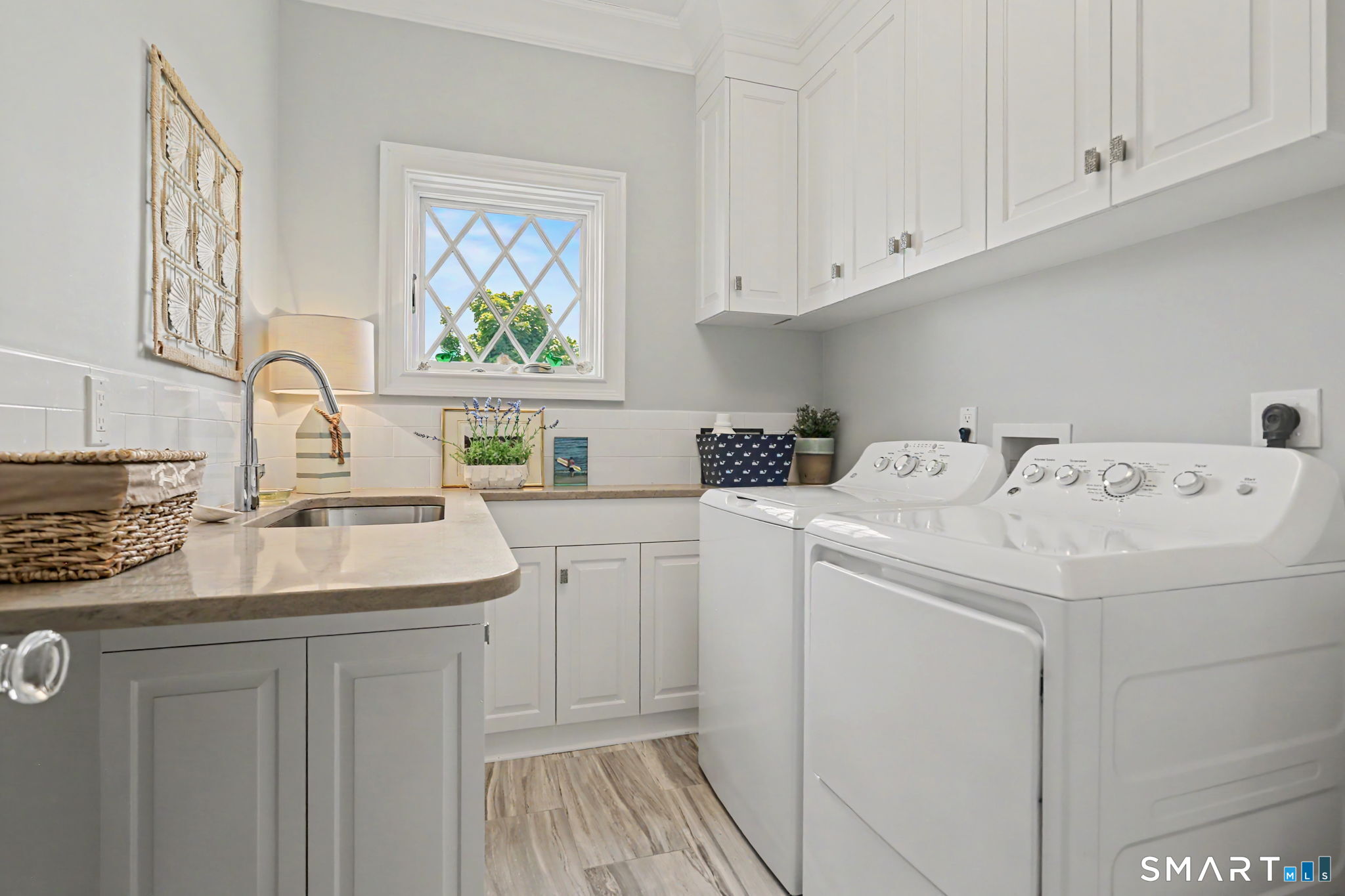 1657 Fairfield Beach Road, Unit 1657 Fairfield, CT 06824 - Photo 29 of 38 second fl. laundry w sink and cabinets