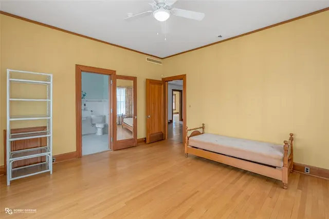 a spacious bedroom with a bed and a chandelier