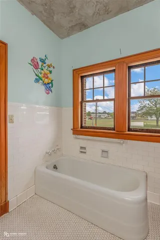 a bathroom with a bathtub and a window