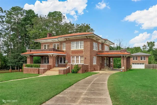 a front view of a house with a yard table and chairs