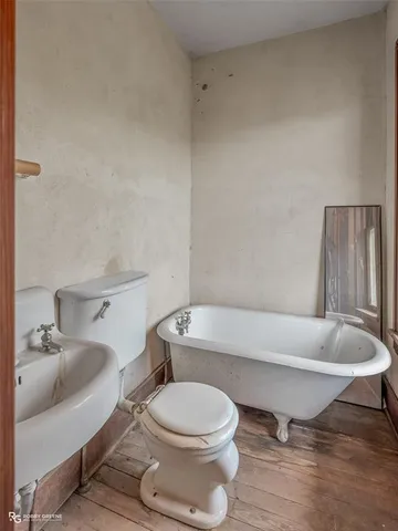a bathroom with a toilet a sink and bathtub