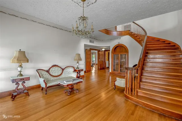 a view of a room with wooden floor and windows