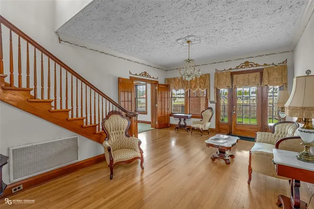 a living room with furniture windows and a chandelier