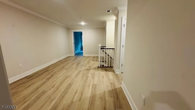 a view of a room with wooden floor and bench