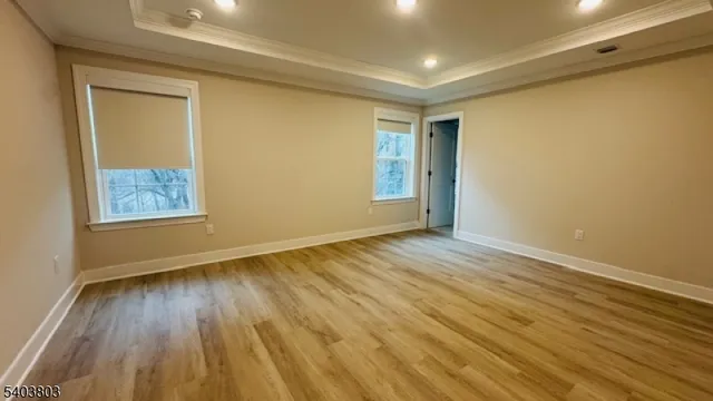 a view of an empty room and wooden floor
