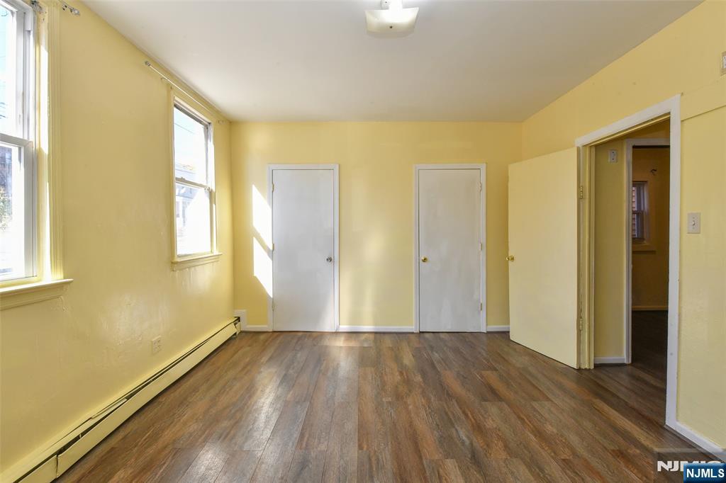 208 4th Street Passaic, NJ 07055 - Photo 15 of 28 a view of wooden floor in an empty room
