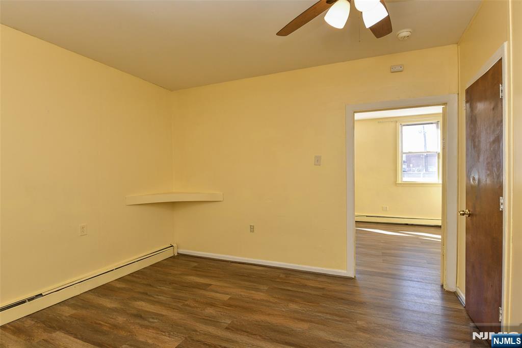 208 4th Street Passaic, NJ 07055 - Photo 20 of 28 a view of empty room with wooden floor