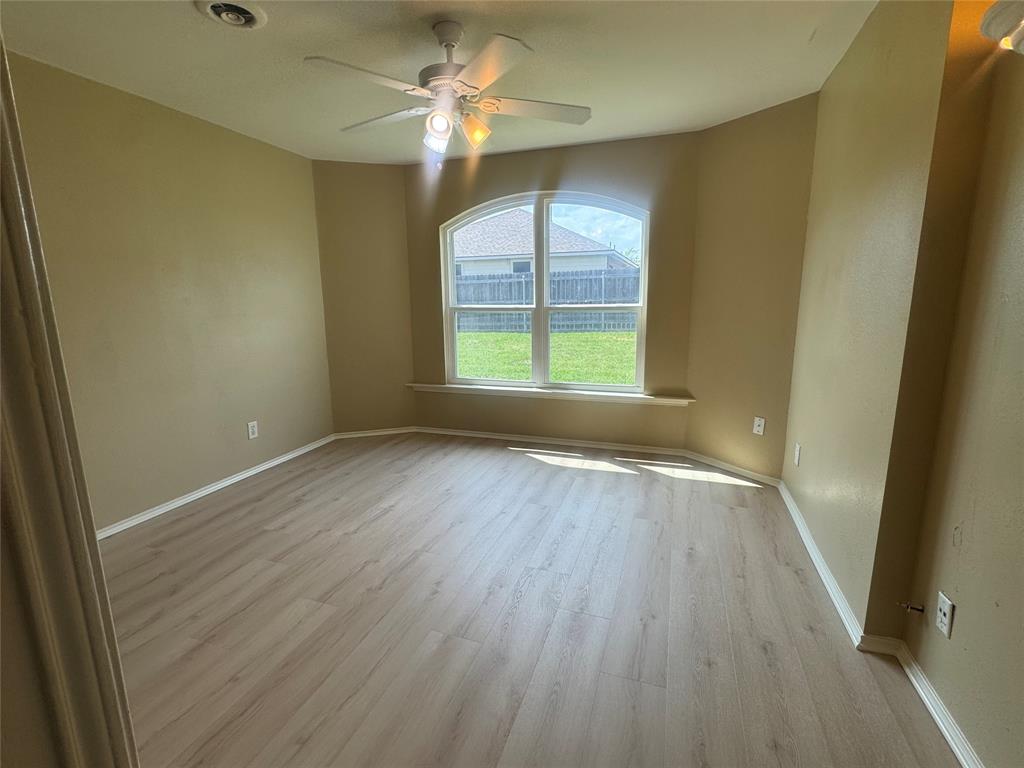 908 Cedar Ridge Lane Burleson, TX 76028 - Photo 9 of 24 wooden floor in an empty room with a window