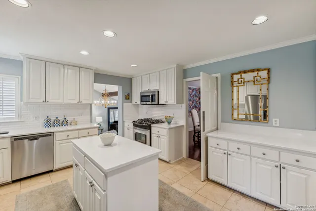 a kitchen with a sink stove and refrigerator