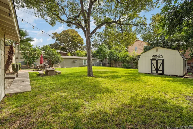 a view of a house with a yard and sitting area