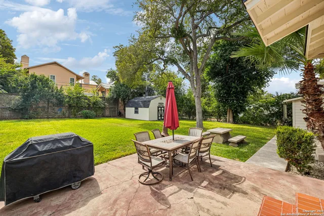 an aerial view of a residential houses with city view