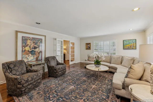 a living room with furniture a table and a window