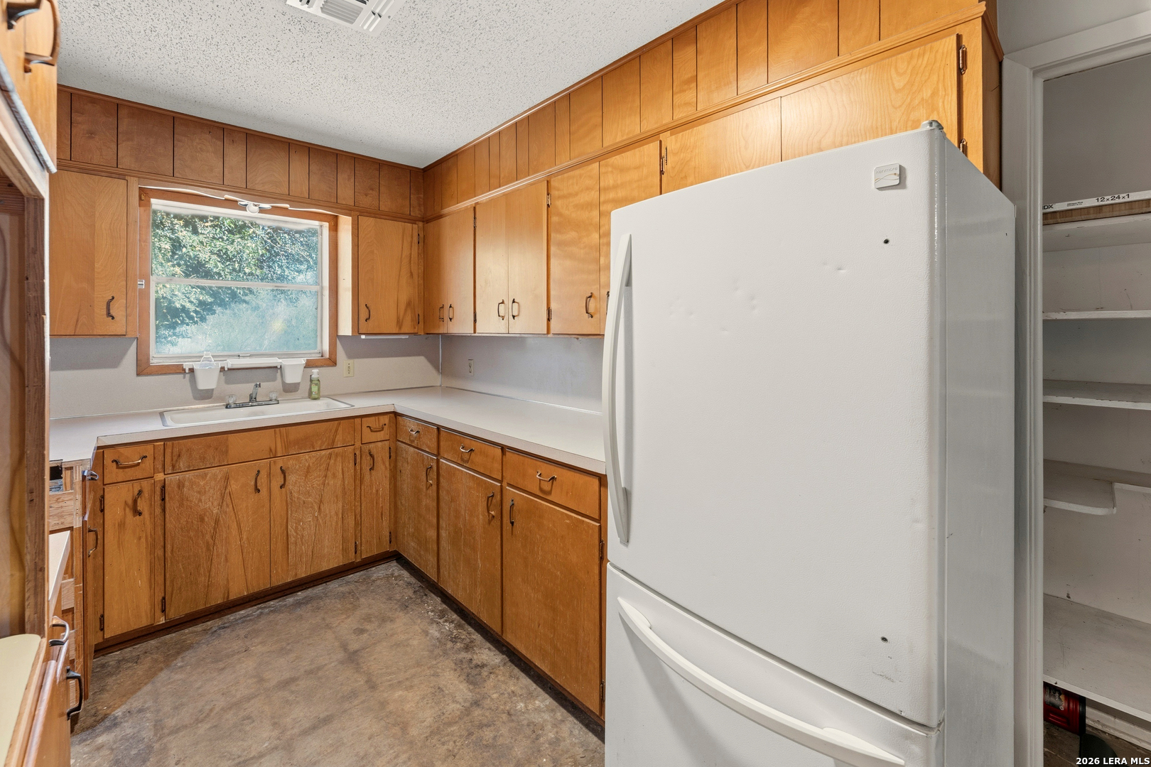 3394 Junction Highway Ingram, TX 78025 - Photo 17 of 28 a kitchen with a refrigerator sink and cabinets