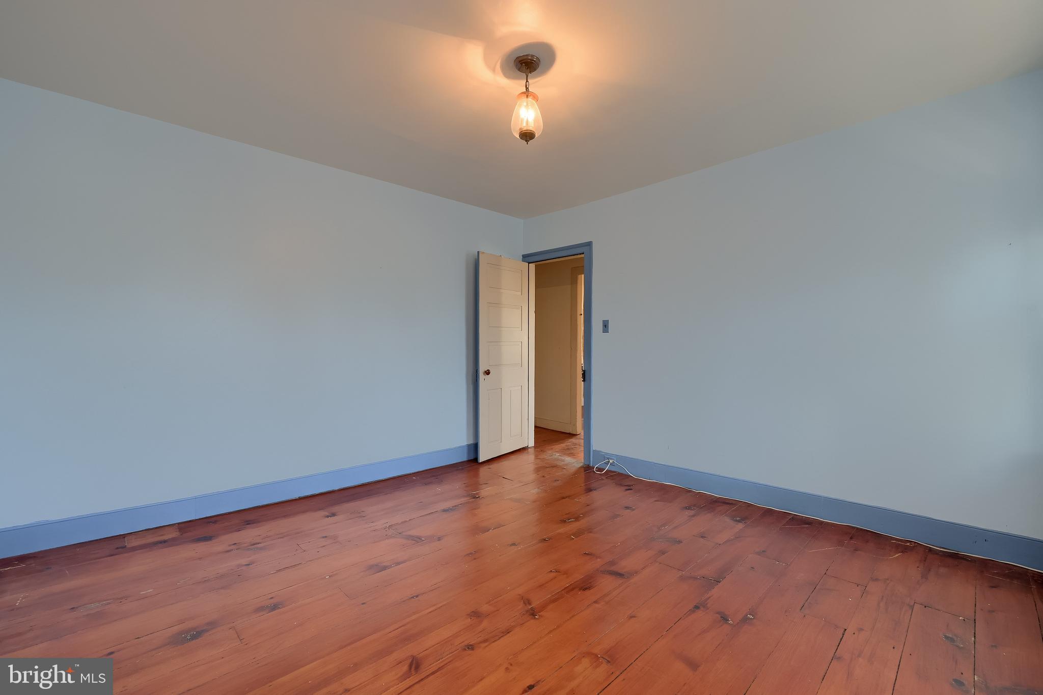 2 South Charlotte Street Manheim, PA 17545 - Photo 55 of 88 a view of an empty room with wooden floor and a ceiling fan