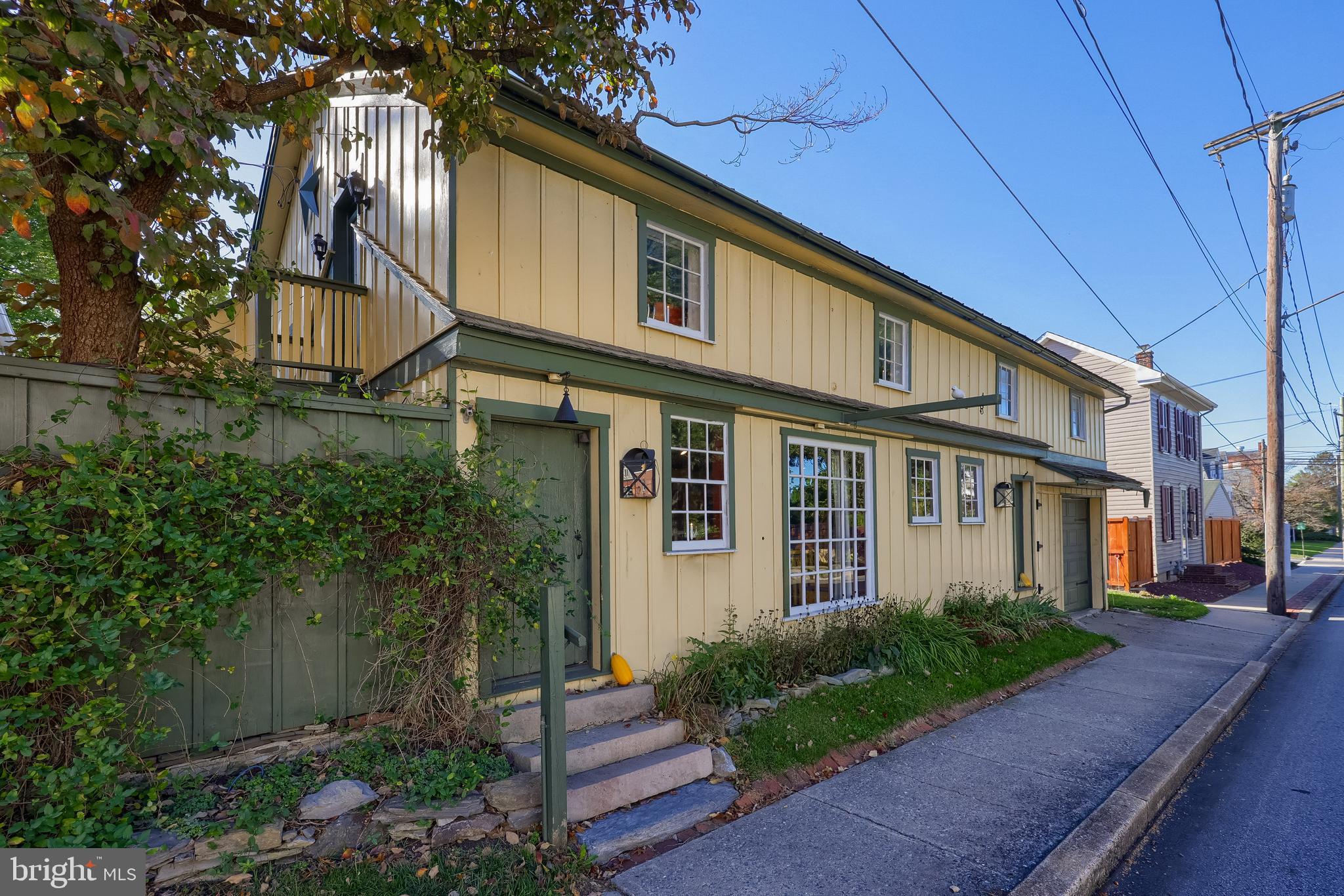 2 South Charlotte Street Manheim, PA 17545 - Photo 6 of 88 a view of a white house next to a yard with potted plants
