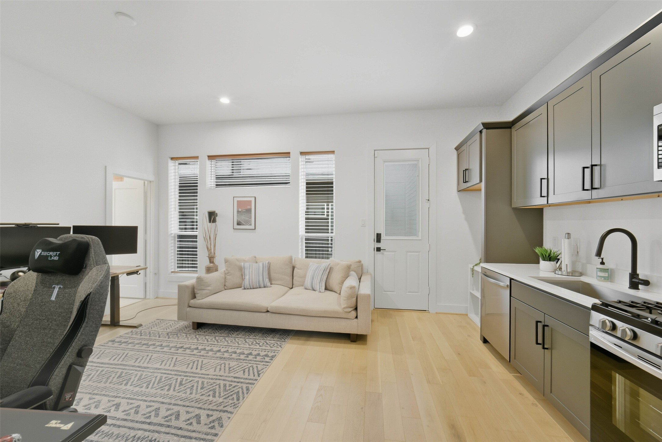 3006 Lamar Street Houston, TX 77003 - Photo 18 of 46 a spacious bedroom with a bed a couch and dresser
