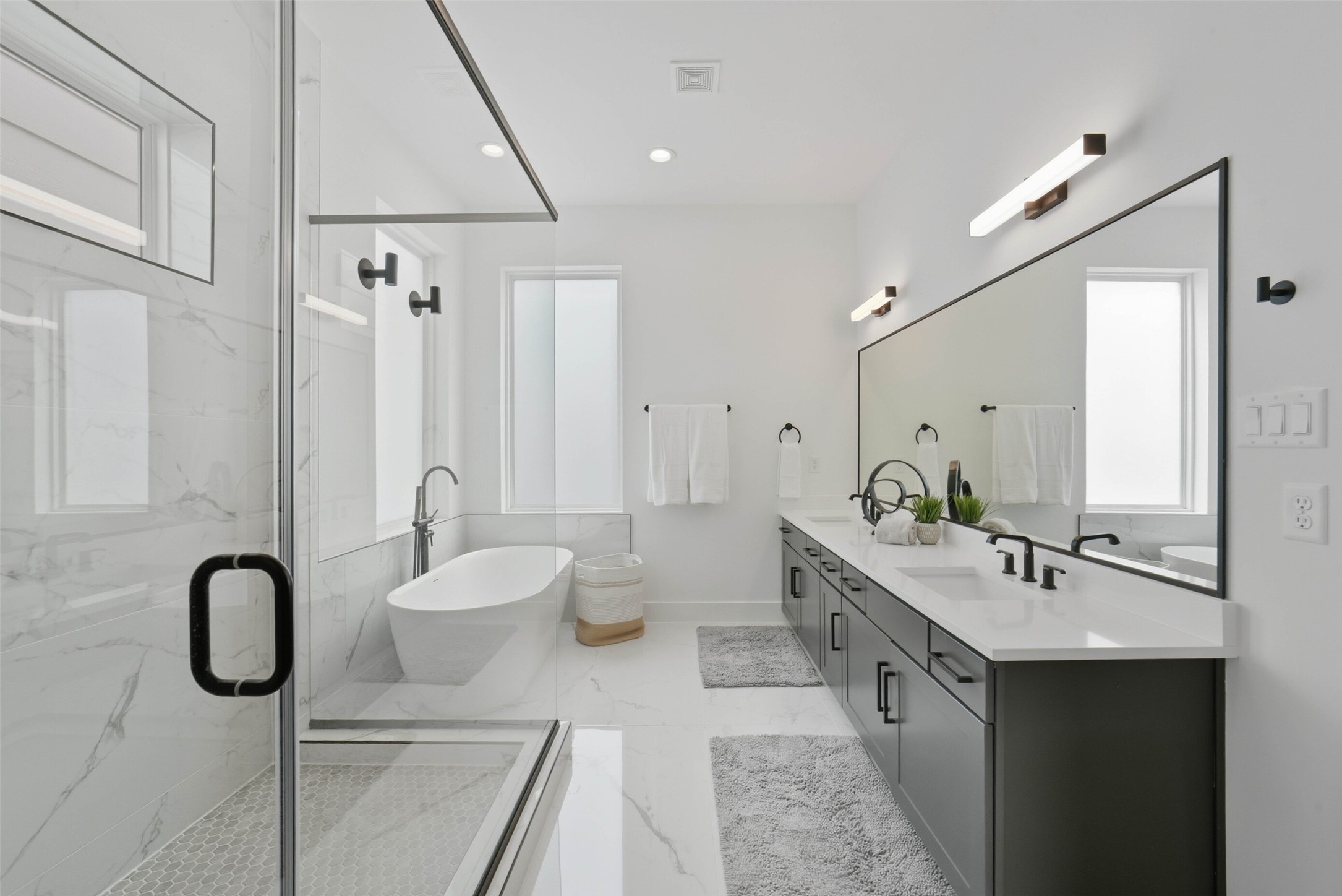 3006 Lamar Street Houston, TX 77003 - Photo 26 of 46 a bathroom with a double vanity sink a mirror and a shower
