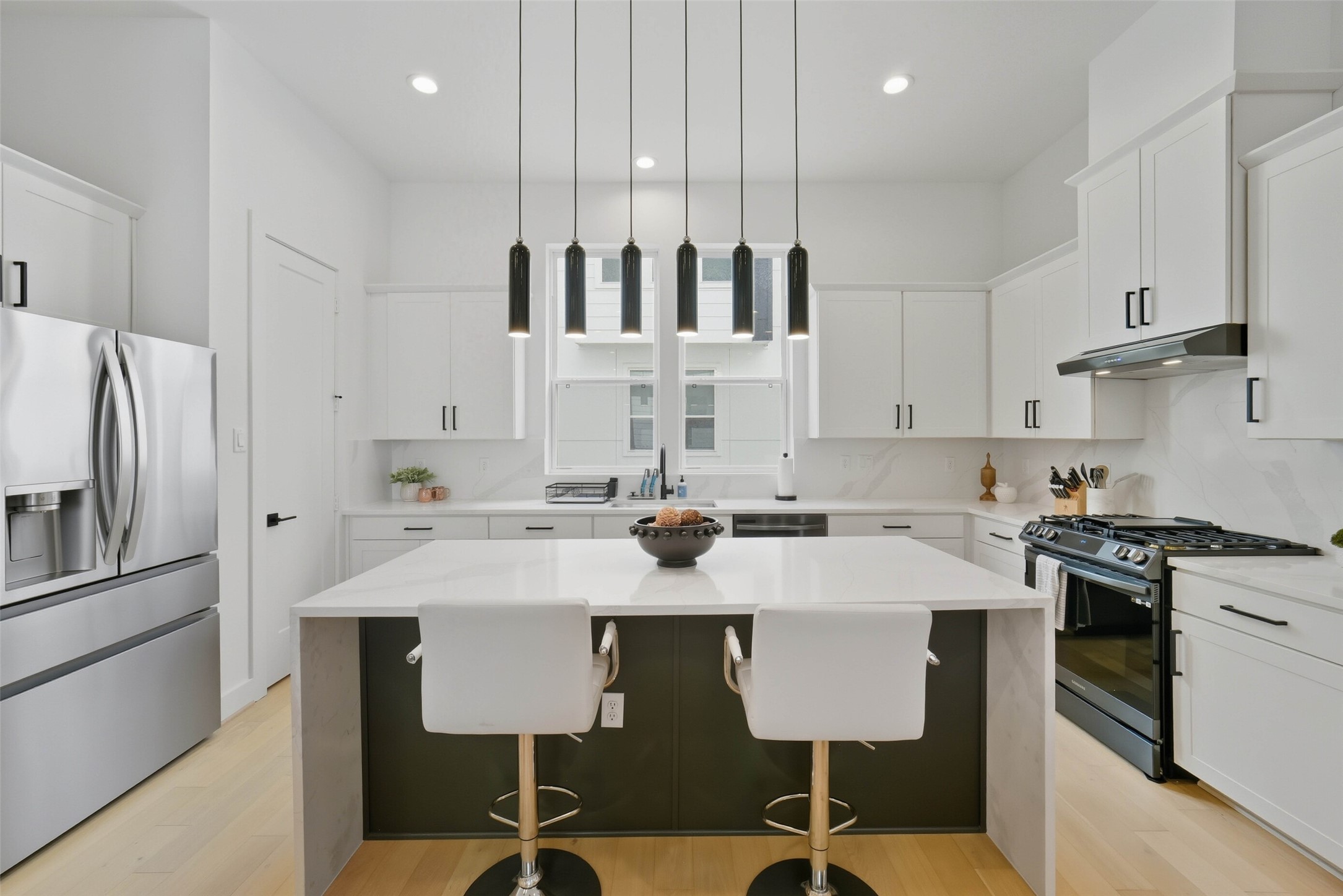 3006 Lamar Street Houston, TX 77003 - Photo 8 of 46 a kitchen with stainless steel appliances granite countertop a sink a stove a refrigerator and white cabinets