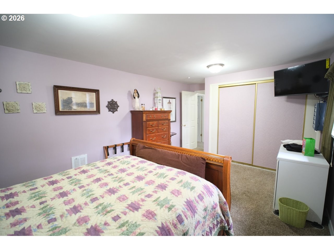 70214 Lakewood Road North Bend, OR 97459 - Photo 21 of 39 a bedroom with a bed and a flat screen tv