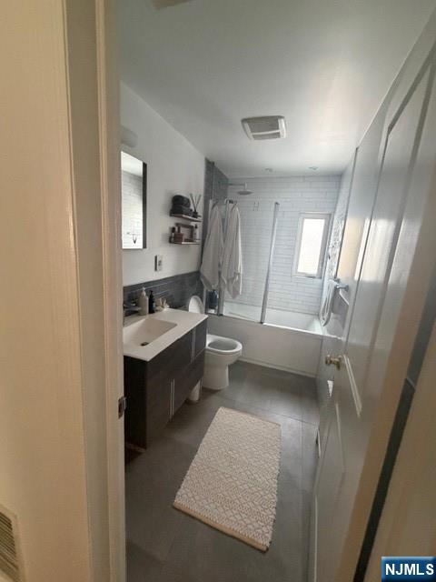 216 Brookside Avenue, Unit 1 Ho-Ho-Kus, NJ 07423 - Photo 6 of 7 a bathroom with a double vanity sink toilet mirror and window