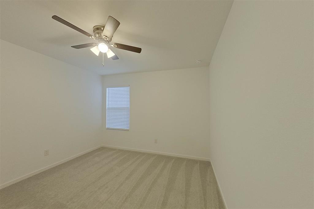 834 Ginkgo Way Princeton, TX 75407 - Photo 11 of 27 an empty room with a window and a fan