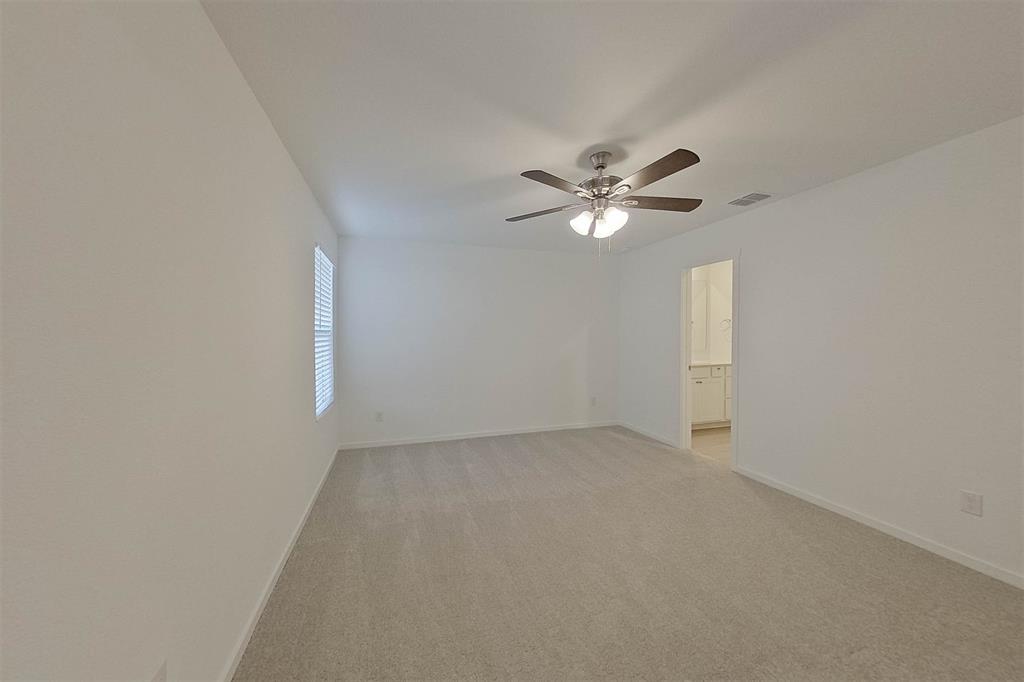 834 Ginkgo Way Princeton, TX 75407 - Photo 15 of 27 an empty room with a window and a ceiling fan