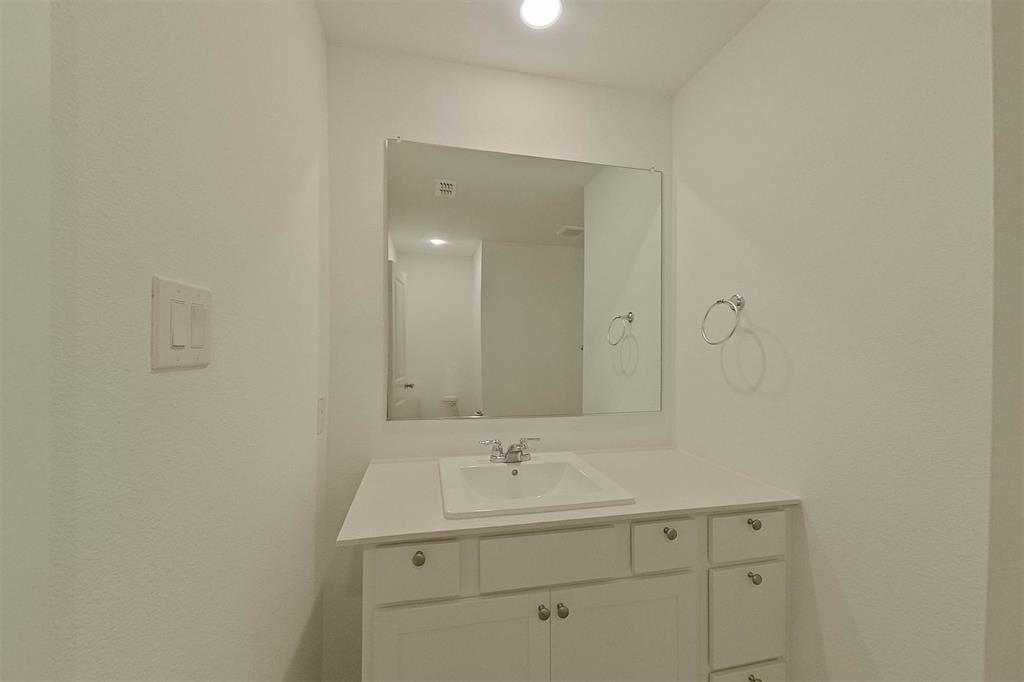 834 Ginkgo Way Princeton, TX 75407 - Photo 17 of 27 a bathroom with a sink and a mirror