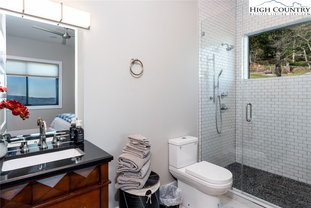 1180 Pinnacle Drive Boone, NC 28607 - Photo 42 of 50 a bathroom with a toilet a sink and a mirror