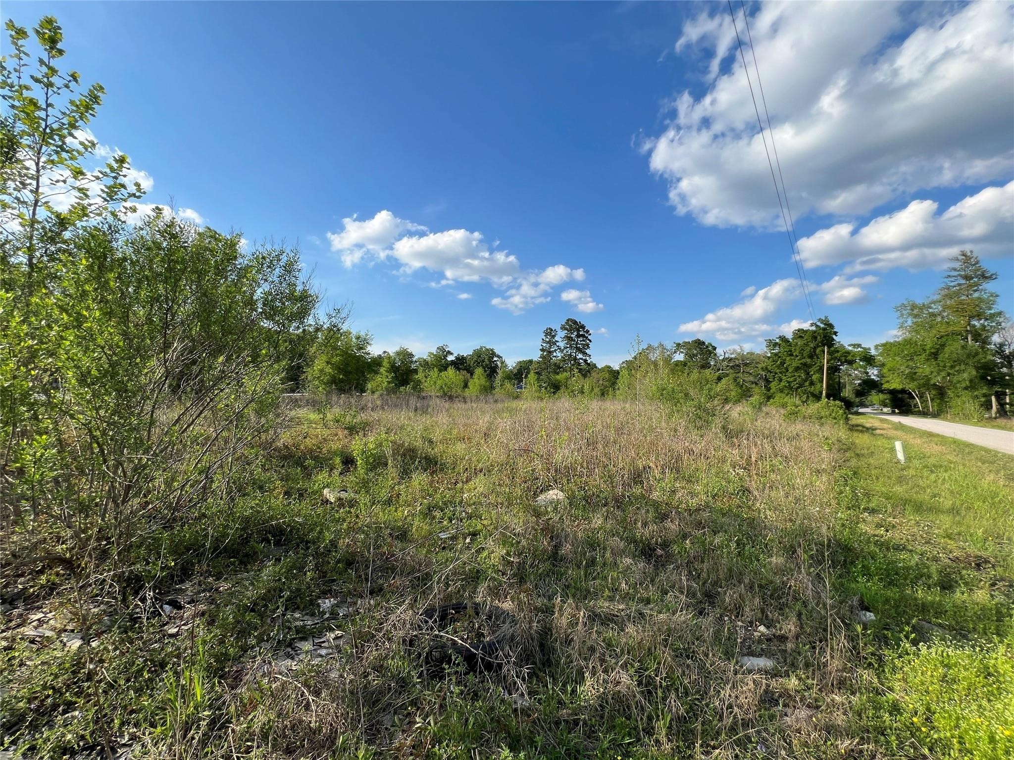 11785 Fostoria Road Cleveland, TX 77328 - Photo 4 of 5 a view of a lake and sunset