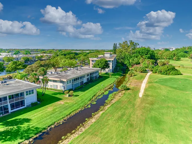 a view of yard with swimming pool and green space