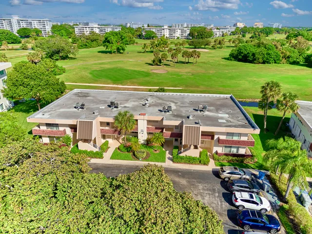 an aerial view of a house with yard green space and outdoor seating