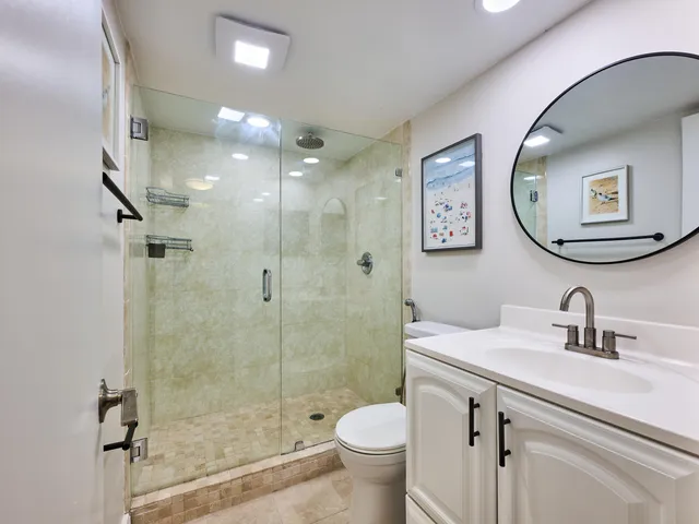 a bathroom with a sink toilet and a mirror