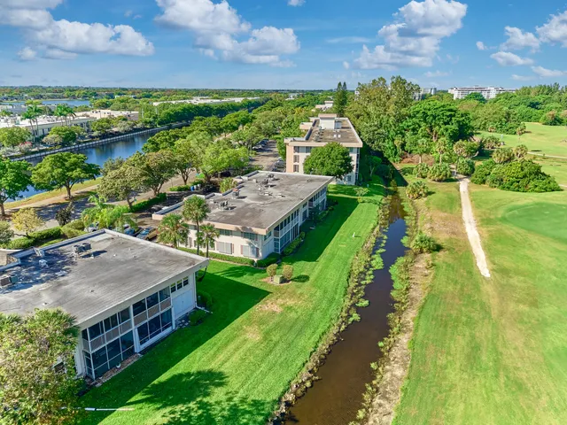 an aerial view of houses with a yard