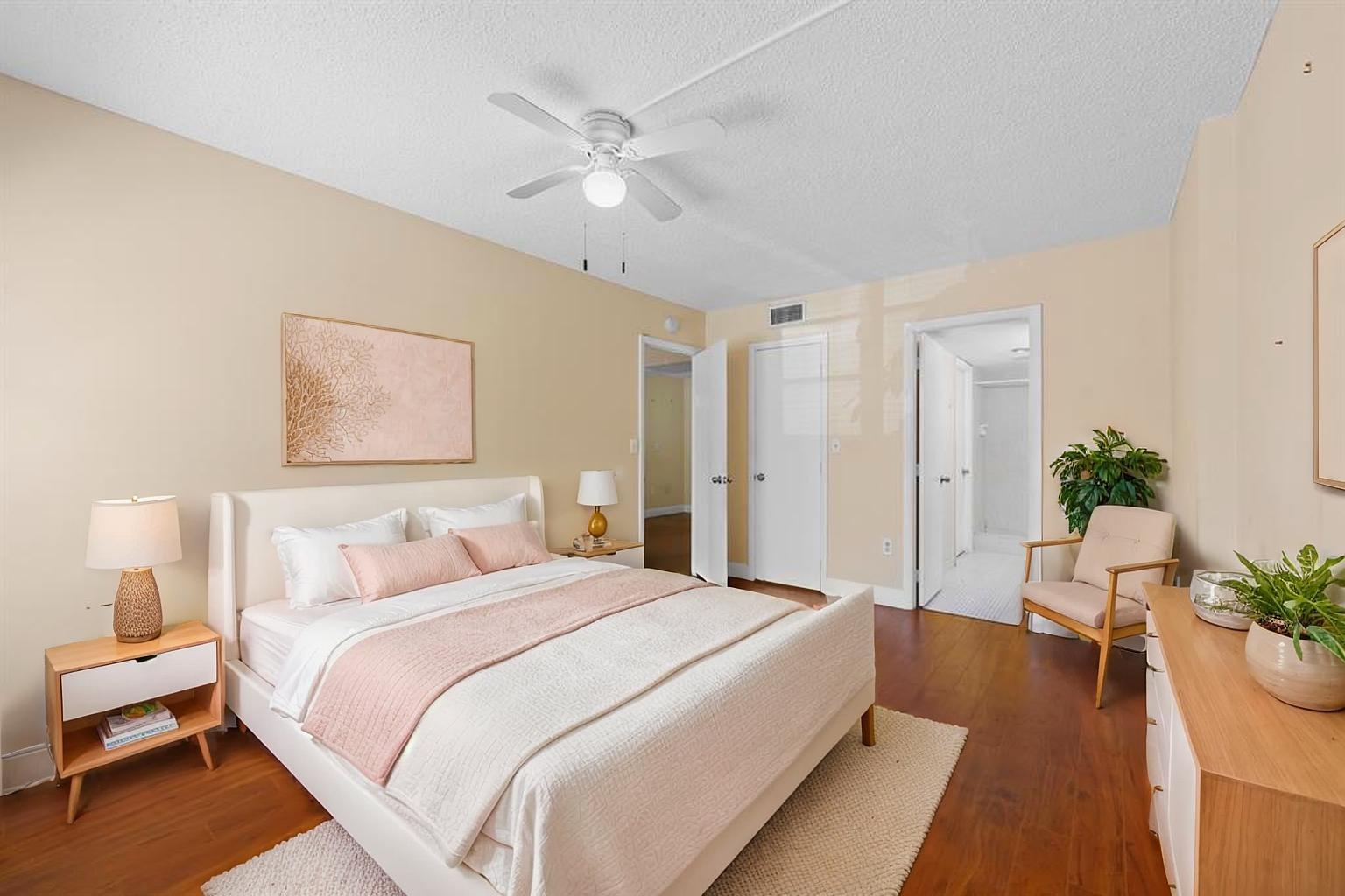 4156 Inverrary Drive, Unit 210 Lauderhill, FL 33319 - Photo 7 of 27 a spacious bedroom with a bed and a chandelier