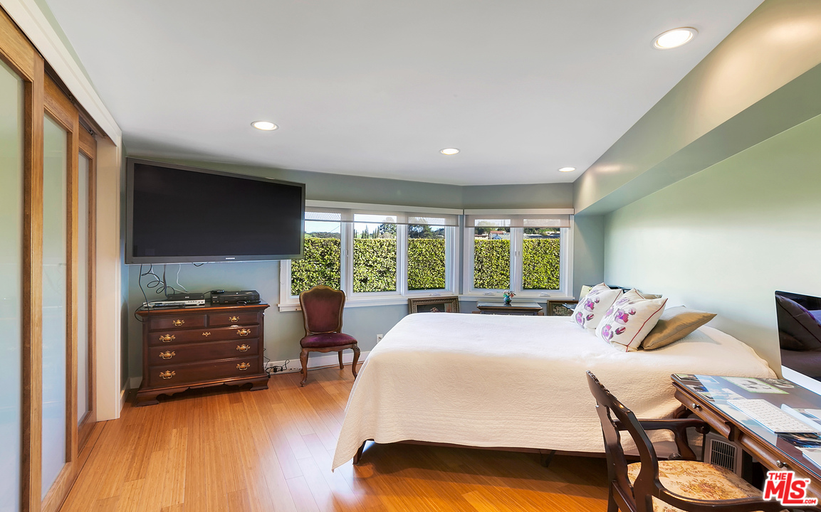 3921 Cody Road Sherman Oaks, CA 91403 - Photo 18 of 36 a bedroom with a bed and a tv