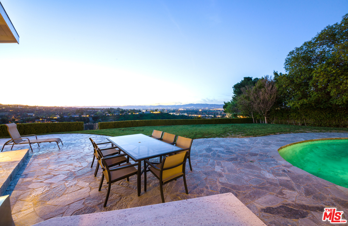 3921 Cody Road Sherman Oaks, CA 91403 - Photo 26 of 36 an outdoor sitting area with furniture and umbrella