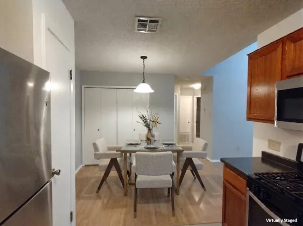 a kitchen with a table and chairs in it