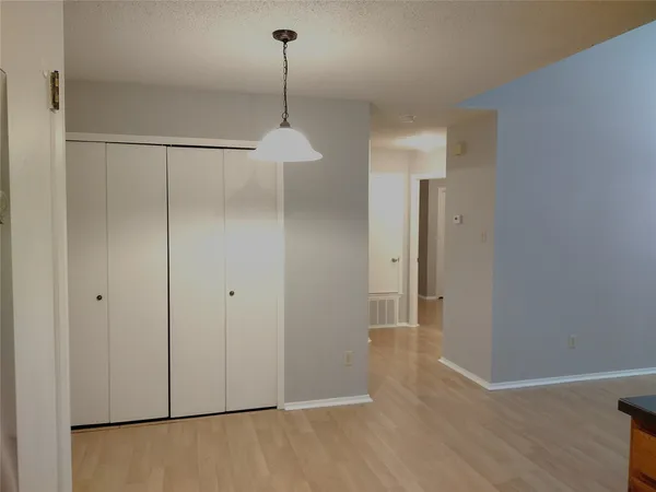 a view of a room with window and wooden floor