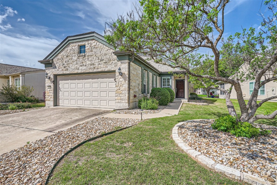 Beautiful entrance with landscaped, low maintenance yard.