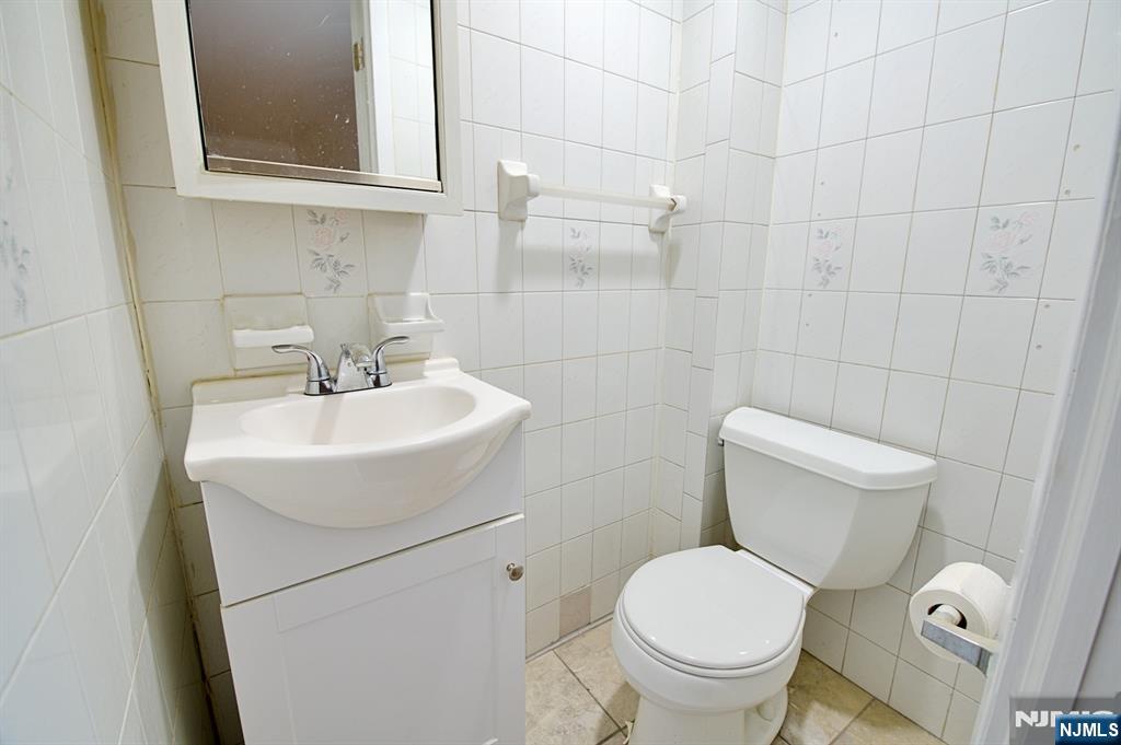 1160 River Road, Unit 1 Edgewater, NJ 07020 - Photo 15 of 18 a white toilet sitting next to a bathroom sink