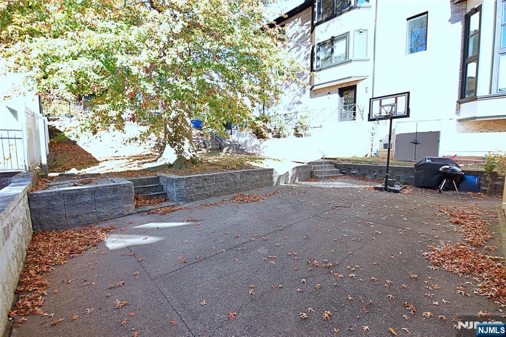 1160 River Road, Unit 1 Edgewater, NJ 07020 - Photo 2 of 18 a row of palm trees in front of a building