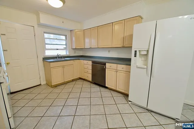 a kitchen with stainless steel appliances a refrigerator sink and cabinets