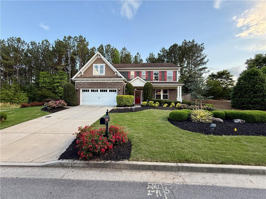 22 Watervine Court Dallas, GA 30132 - Photo 11 of 90 a front view of a house with a garden and yard