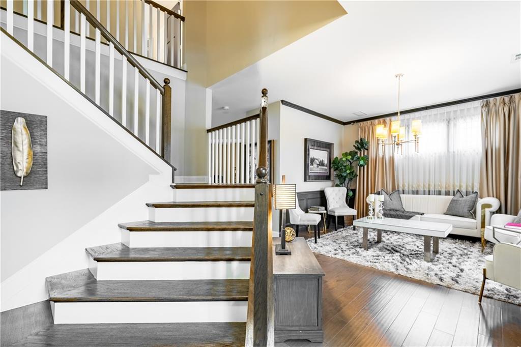22 Watervine Court Dallas, GA 30132 - Photo 23 of 90 a living room with couches potted plants with wooden floor and a large window