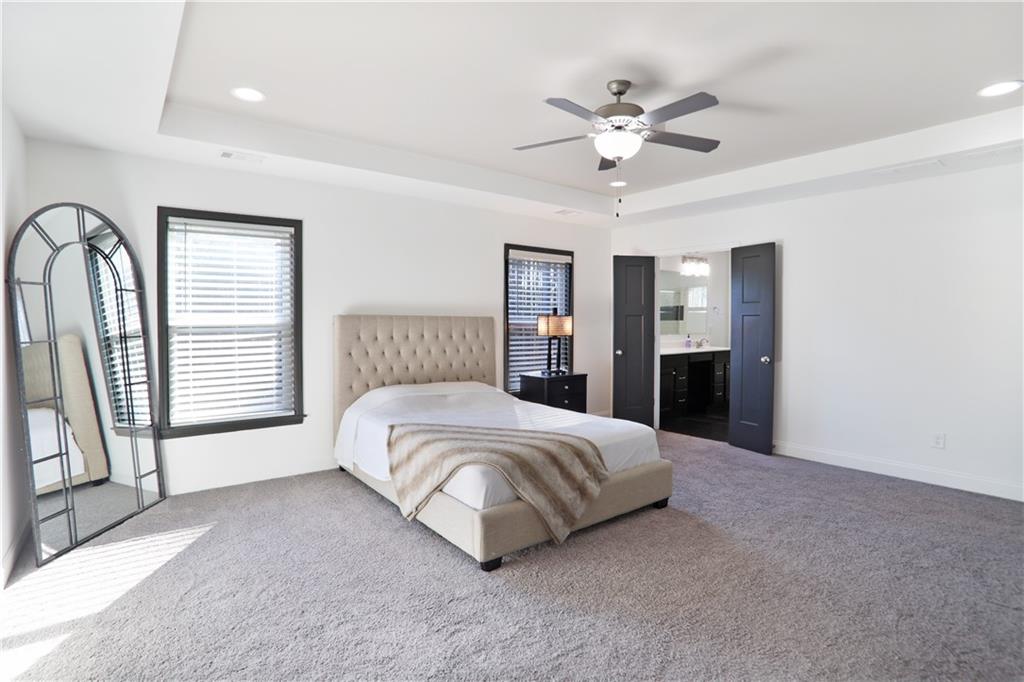 22 Watervine Court Dallas, GA 30132 - Photo 48 of 90 a spacious bedroom with a large bed and a chandelier