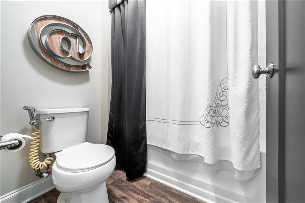 22 Watervine Court Dallas, GA 30132 - Photo 61 of 90 a bathroom with a toilet and a shower curtain
