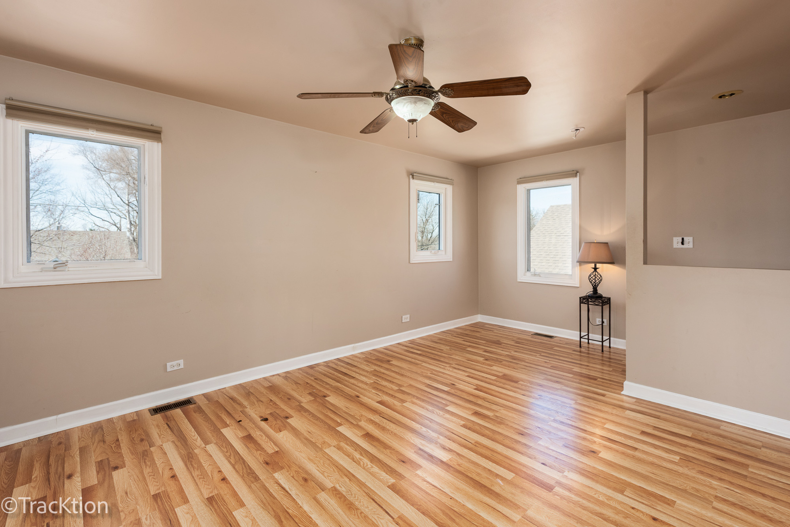 8829 Skyline Drive Burr Ridge, IL 60527 - Photo 13 of 32 a view of empty room with wooden floor and fan