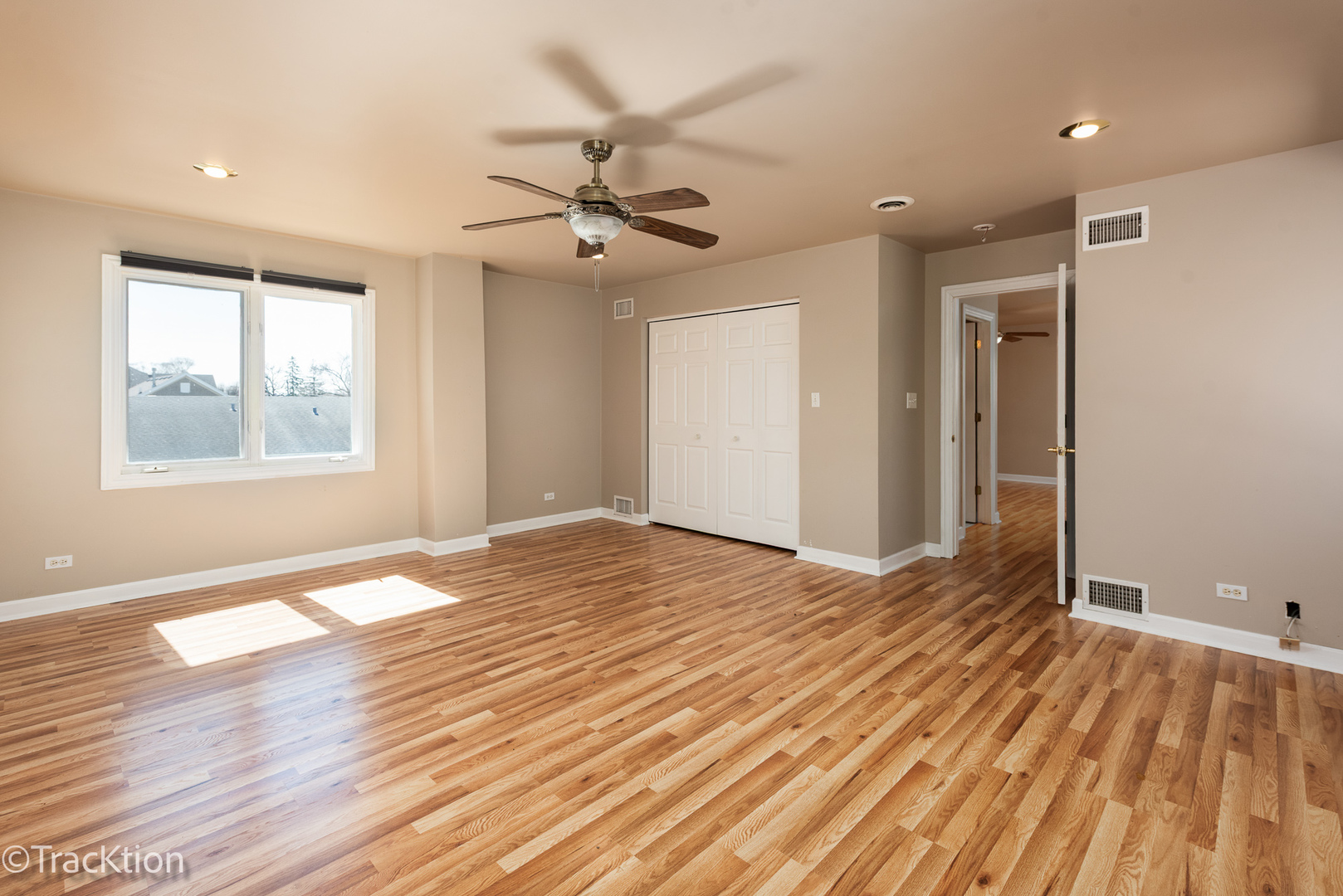 8829 Skyline Drive Burr Ridge, IL 60527 - Photo 16 of 32 a view of empty room with wooden floor and fan