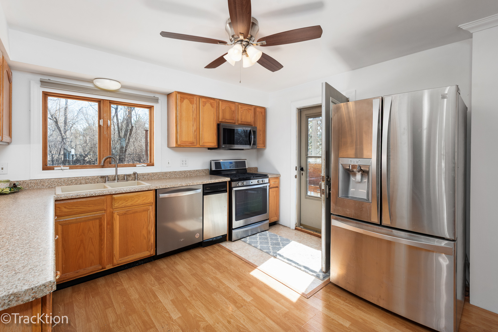 8829 Skyline Drive Burr Ridge, IL 60527 - Photo 3 of 32 a kitchen with stainless steel appliances a refrigerator sink and microwave